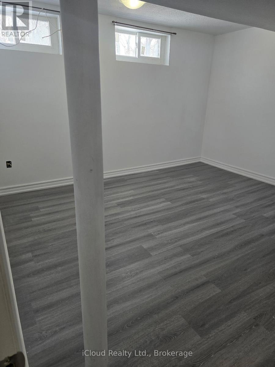 A room with grey flooring and white walls.