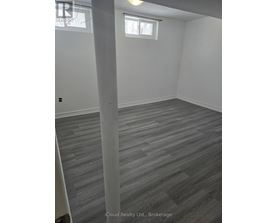 A room with grey flooring and white walls.