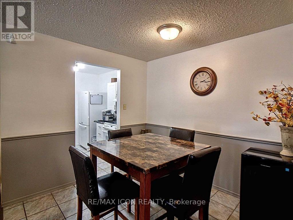 A dining room with a table and chairs.