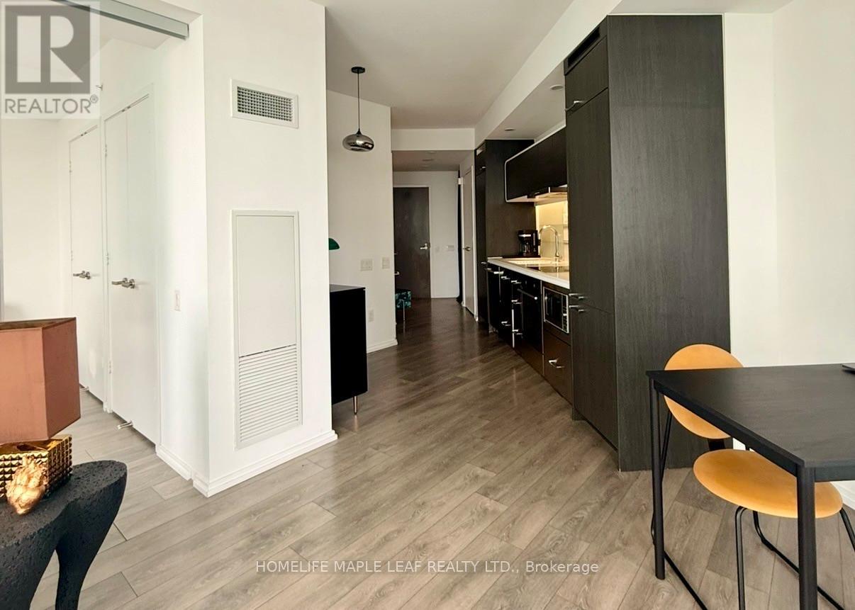 A modern kitchen with a dining table and chairs.
