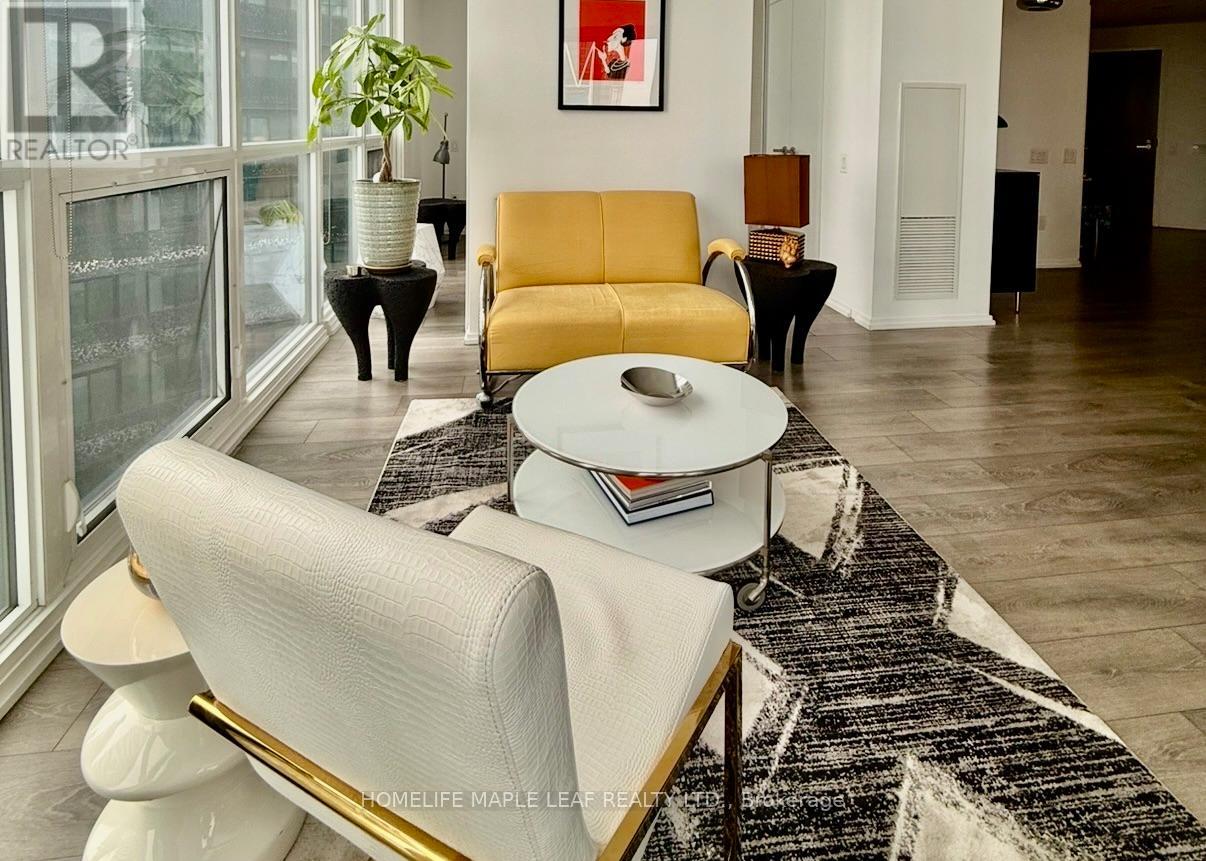 A living room with a white sofa and a yellow chair.