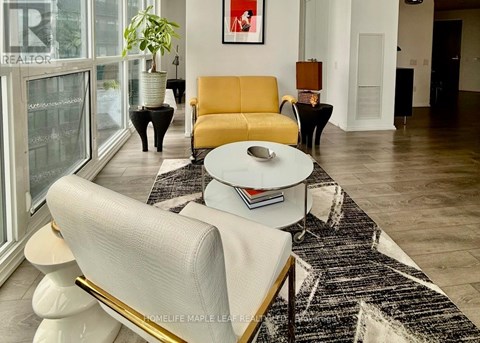 A living room with a white sofa and a yellow chair.