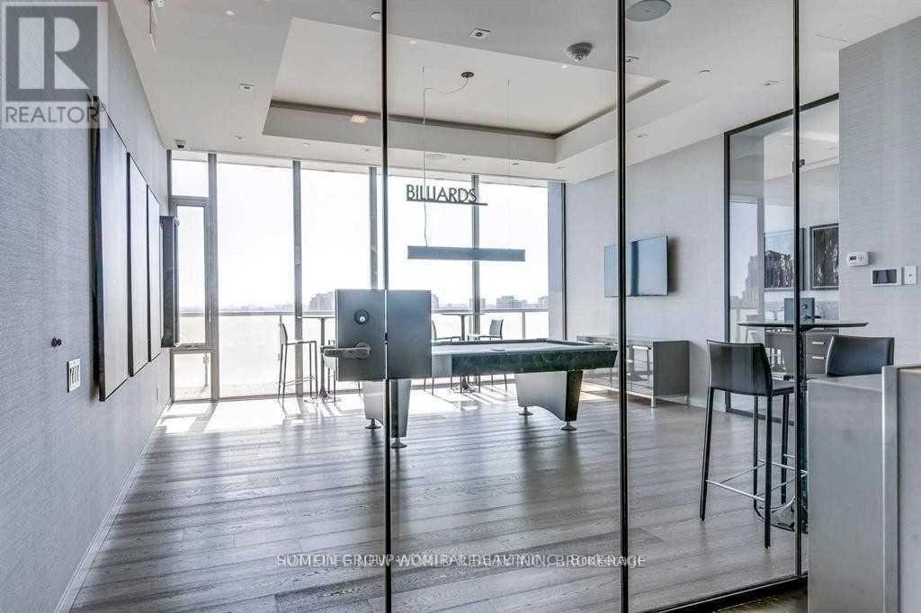A modern dining room with a large table and chairs.