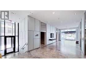 A spacious lobby with marble floors and a staircase leading to the second floor.