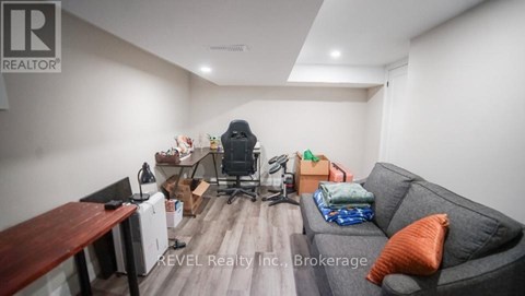 A living room with a grey couch and a wooden table.