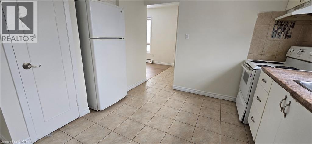 A kitchen with white appliances and cabinets.