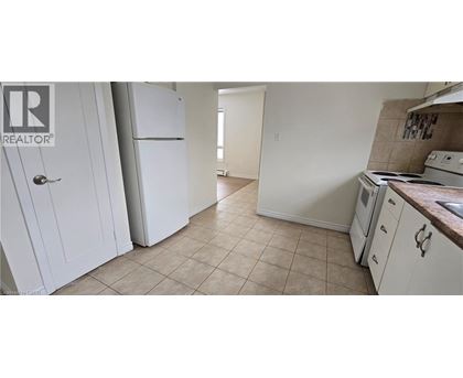 A kitchen with white appliances and cabinets.