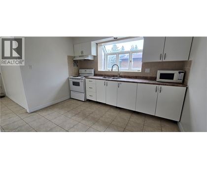 A kitchen with white cabinets and appliances.