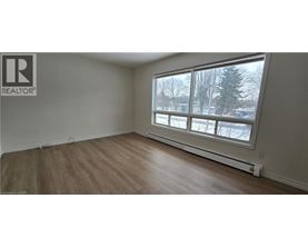 A room with a window showing a snowy landscape outside.