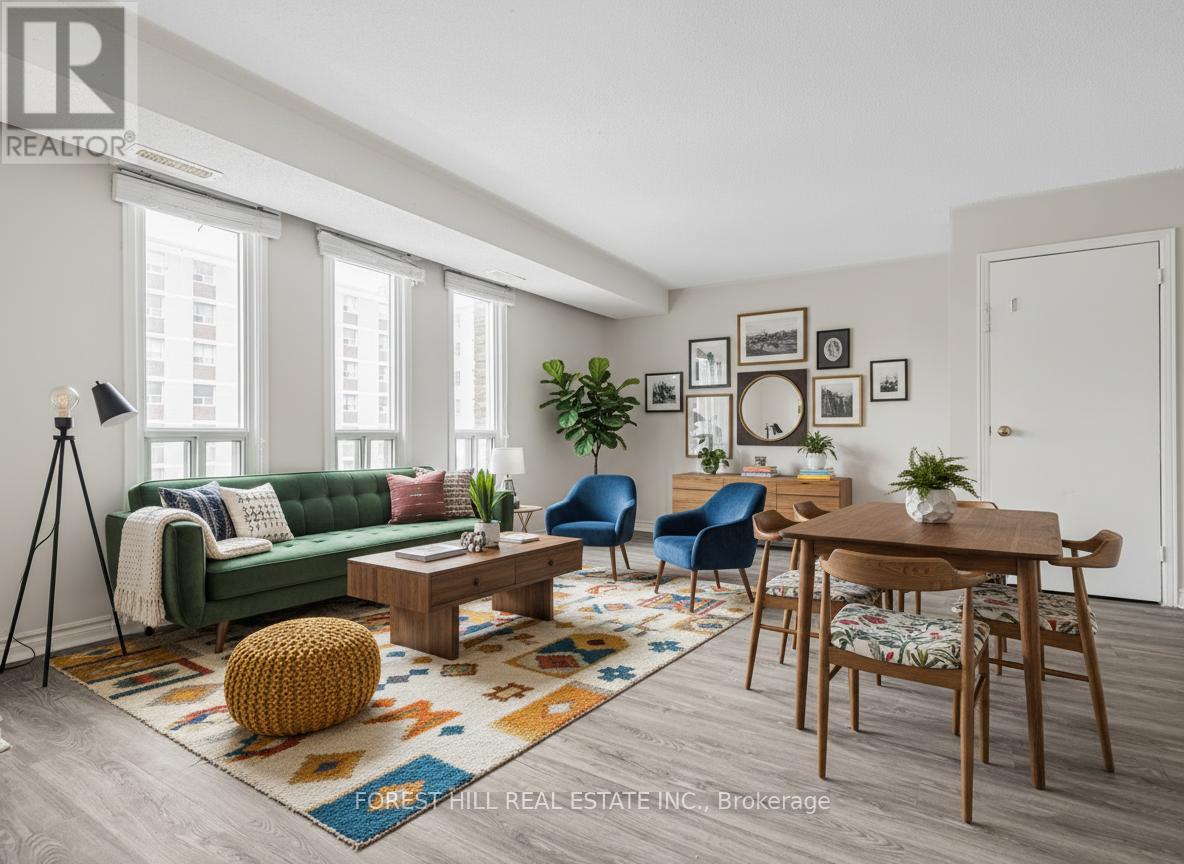 A living room with a green couch, a coffee table, and a rug with a pattern.