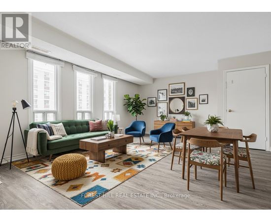 A living room with a green couch, a coffee table, and a rug with a pattern.