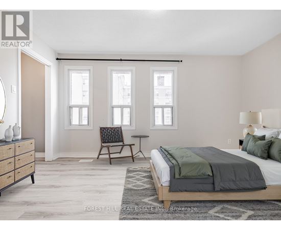 A bedroom with a bed, chair, and a dresser.