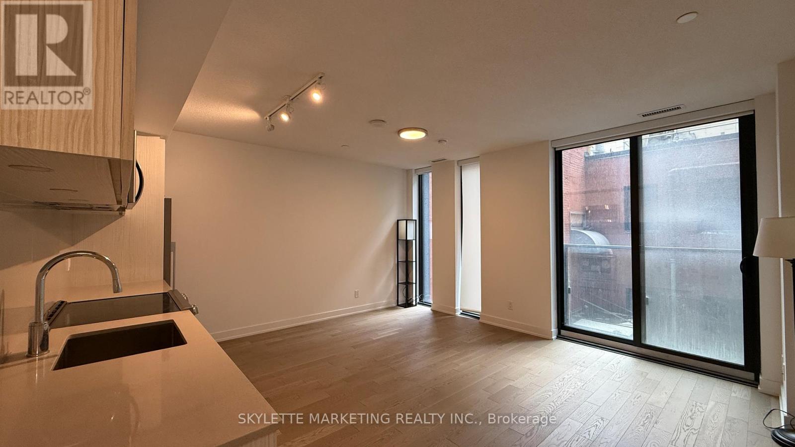 A realtor company is showcasing a property with a kitchen area.