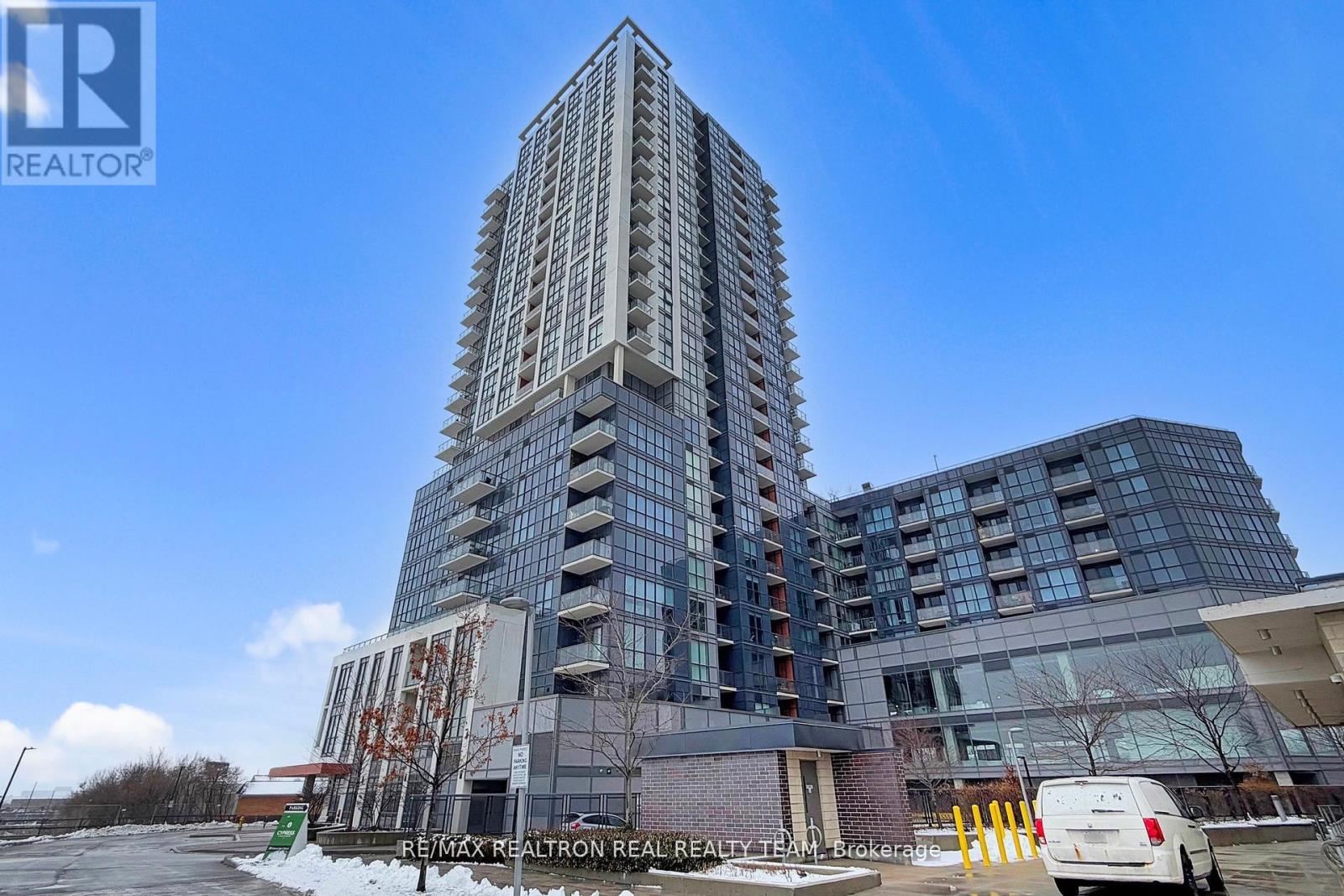 A tall building with many windows is the main focus of the image.