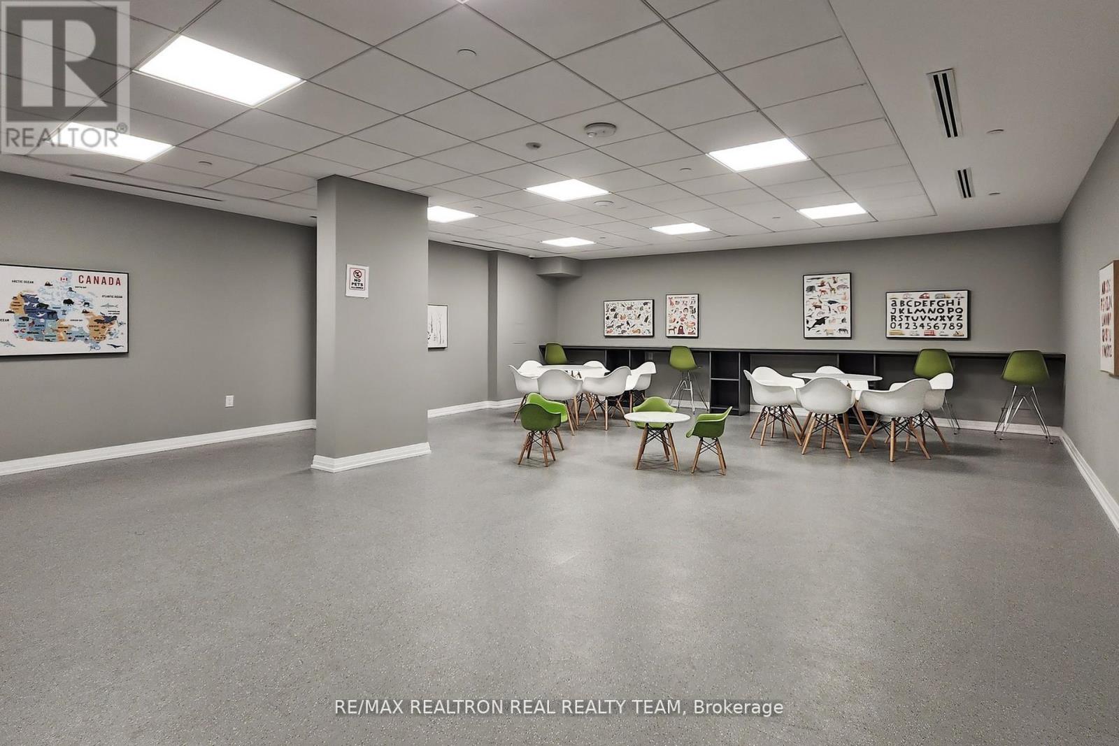 A conference room with a grey floor and white walls.