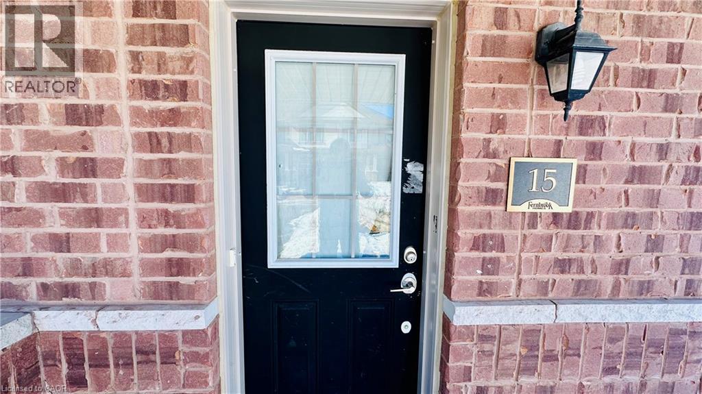 A black door with a glass window and a sign above it that says 15 Potters.