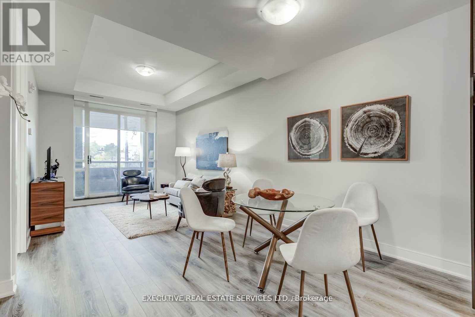 A dining room with a white table and chairs.