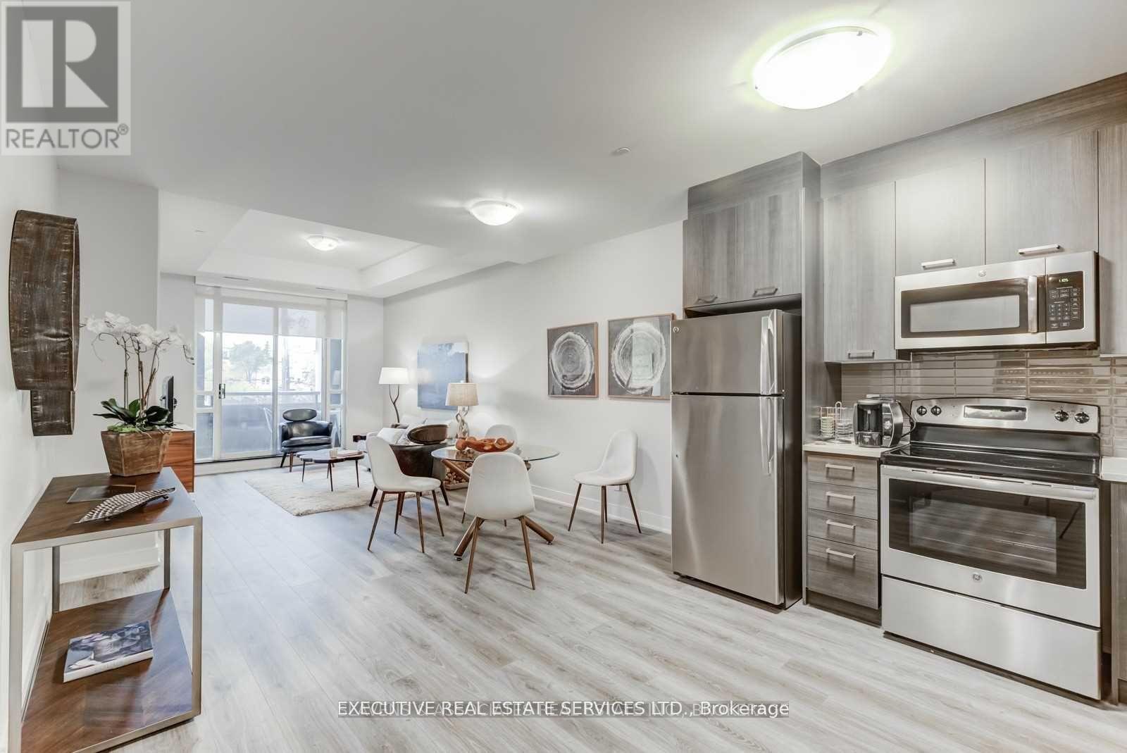 A modern kitchen with stainless steel appliances and white cabinets.