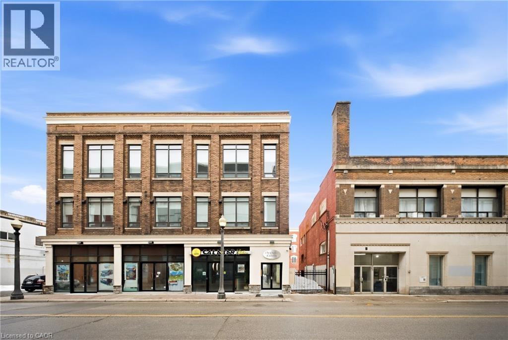 A street view of a building with a REALTOR® sign.