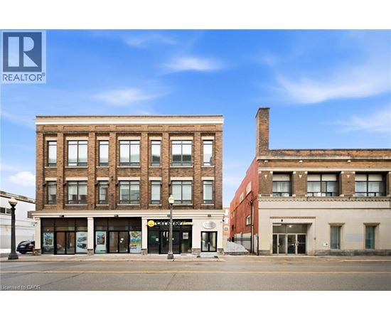 A street view of a building with a REALTOR® sign.