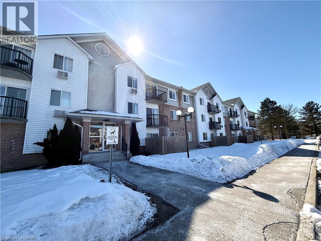 A sunny day at a residential area with apartment buildings and snow on the ground.