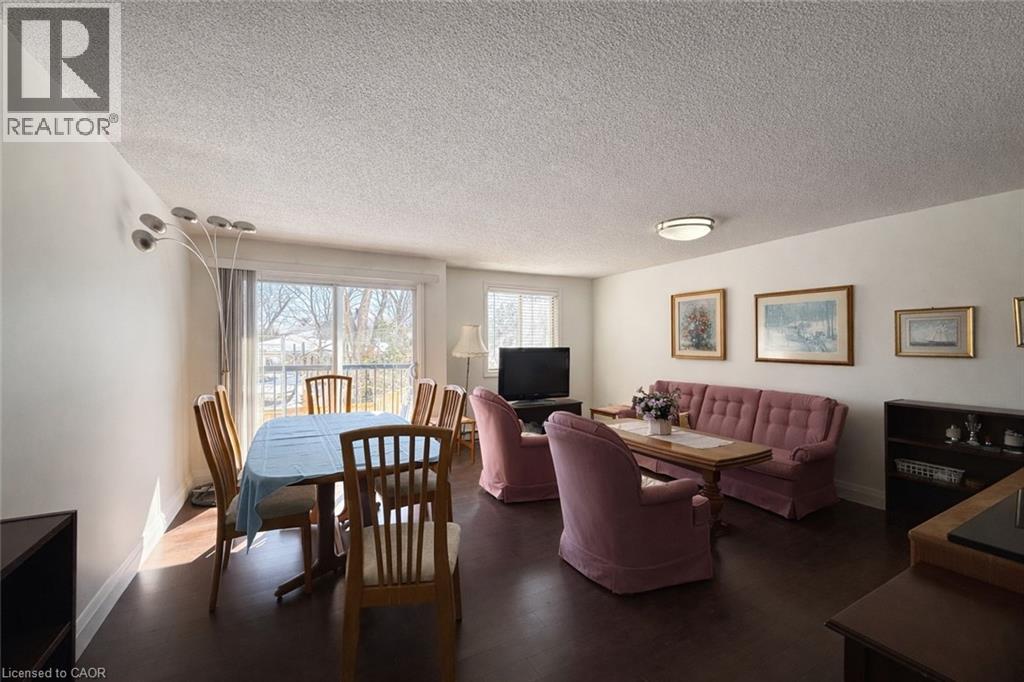 A living room with a pink couch and a wooden table.
