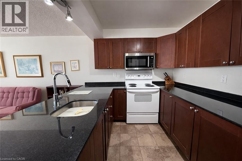 A kitchen with brown cabinets and a white stove top oven.