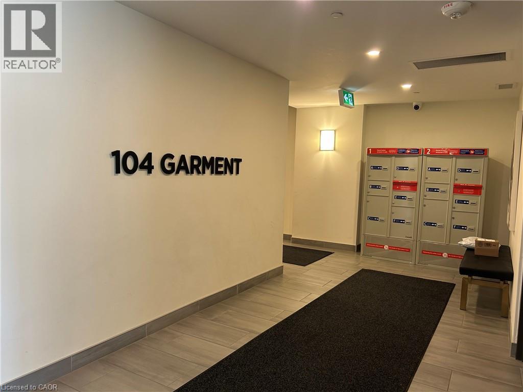 A hallway with a sign that says "104 GARMENT" on the wall.