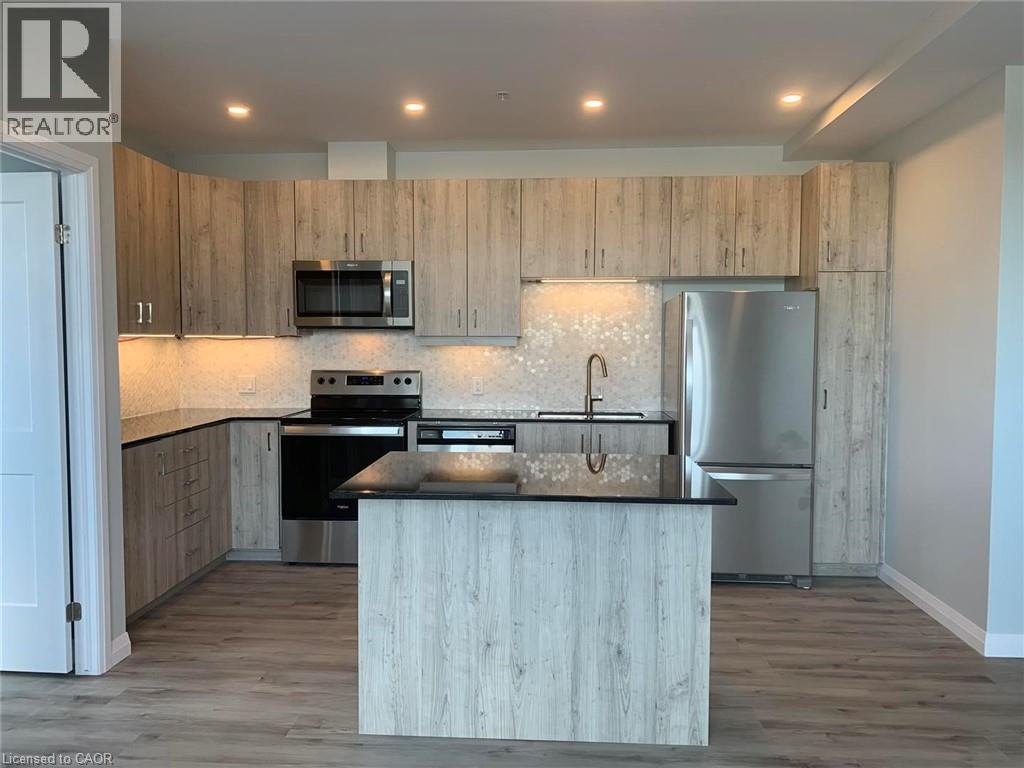 A kitchen with wooden cabinets and a stainless steel refrigerator.