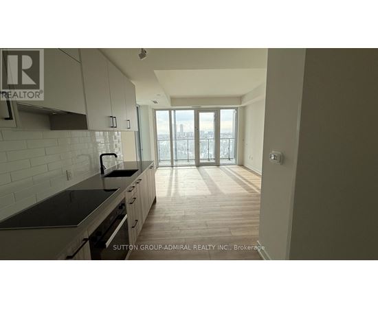 A kitchen with a view of the city through the windows.