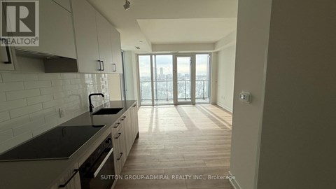 A kitchen with a view of the city through the windows.