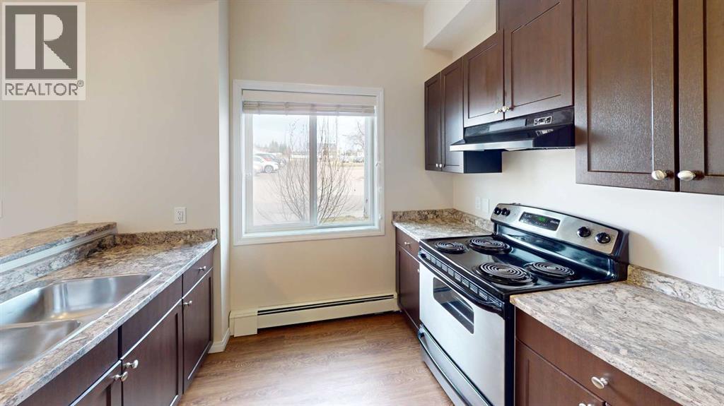 A kitchen with brown cabinets and a stove top oven.