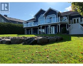 A house with a stone wall in front of it.