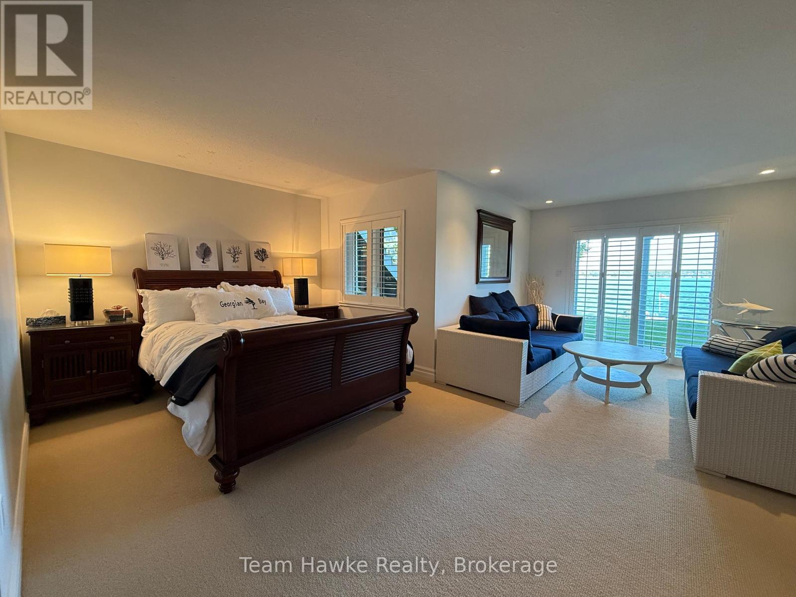 A bedroom with a large bed and a couch.