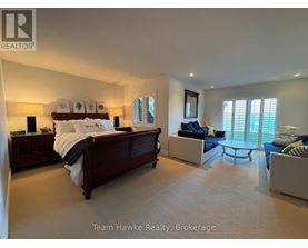 A bedroom with a large bed and a couch.