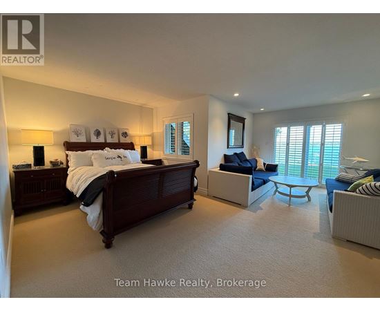 A bedroom with a large bed and a couch.