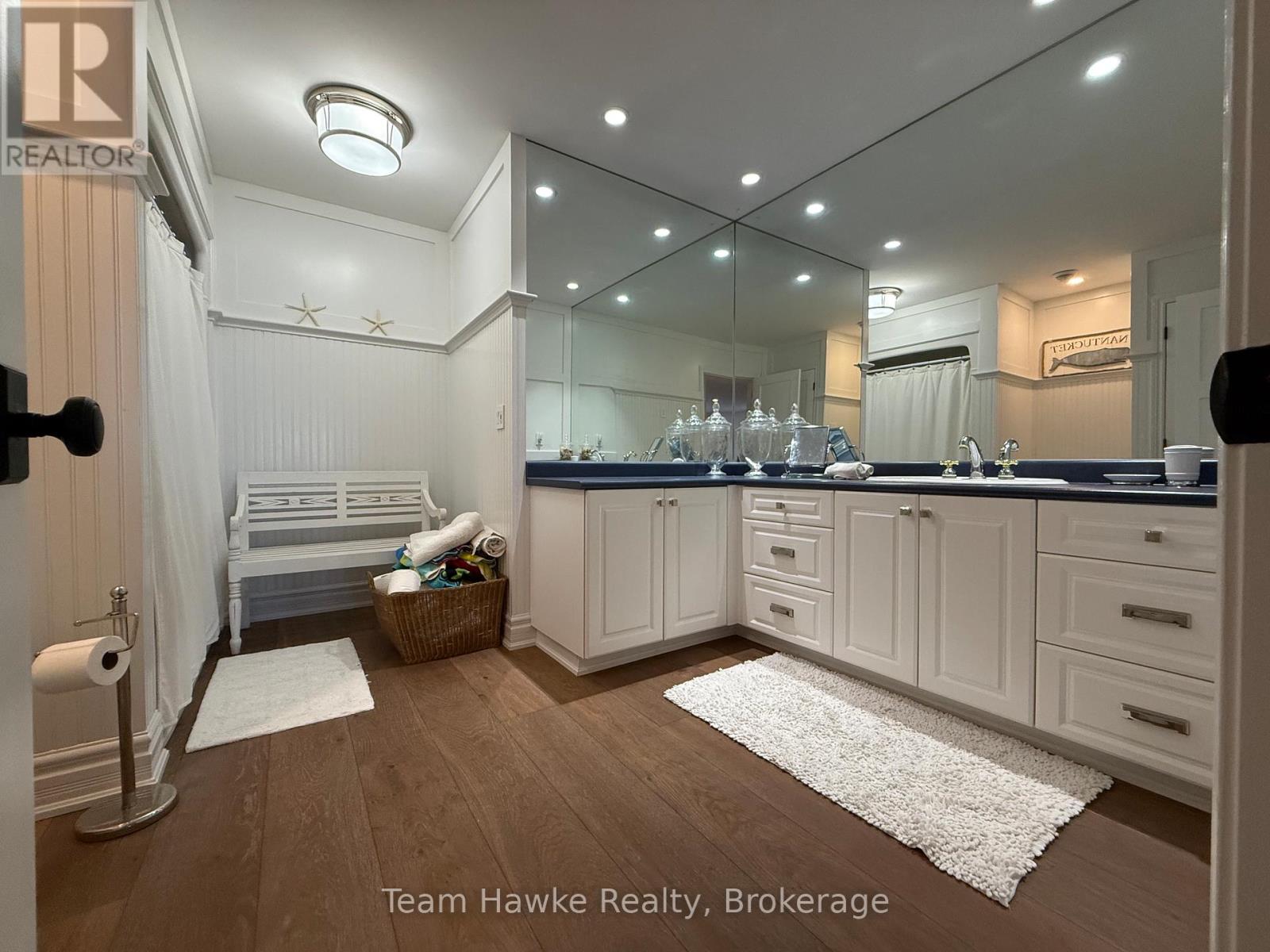 A well-lit, modern kitchen with white cabinets and a large island.