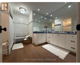 A well-lit, modern kitchen with white cabinets and a large island.