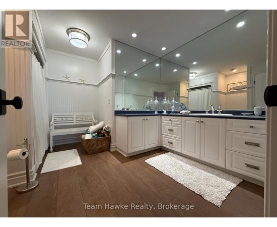 A well-lit, modern kitchen with white cabinets and a large island.