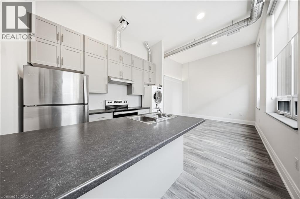 A modern kitchen with stainless steel appliances and a large island.