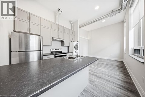 A modern kitchen with stainless steel appliances and a large island.