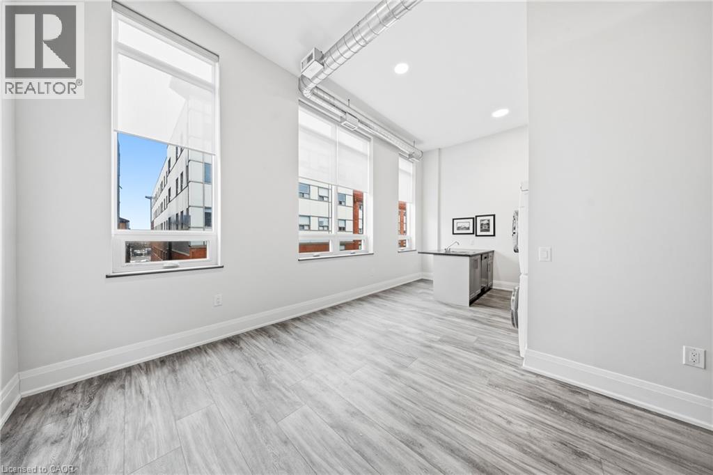 A spacious room with a large window and a view of a building outside.