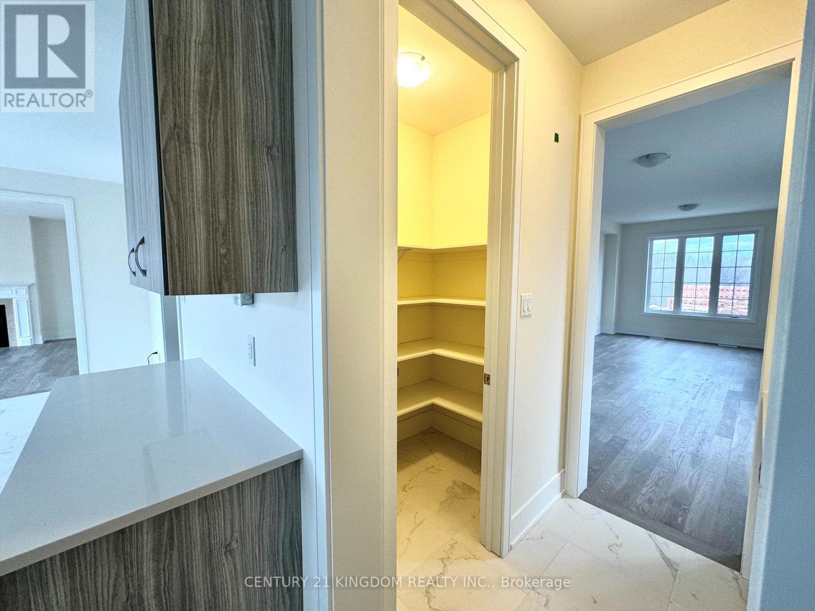 A real estate listing photo of a kitchen area with a counter and cabinets.