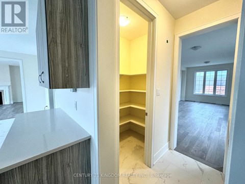 A real estate listing photo of a kitchen area with a counter and cabinets.