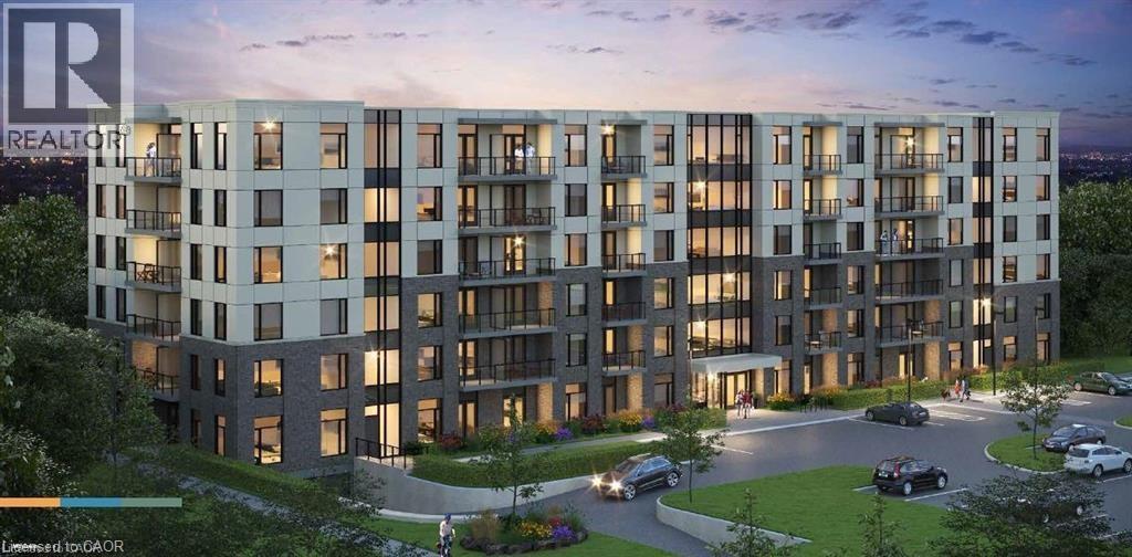 A modern apartment building with a parking lot in front.