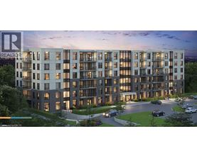 A modern apartment building with a parking lot in front.