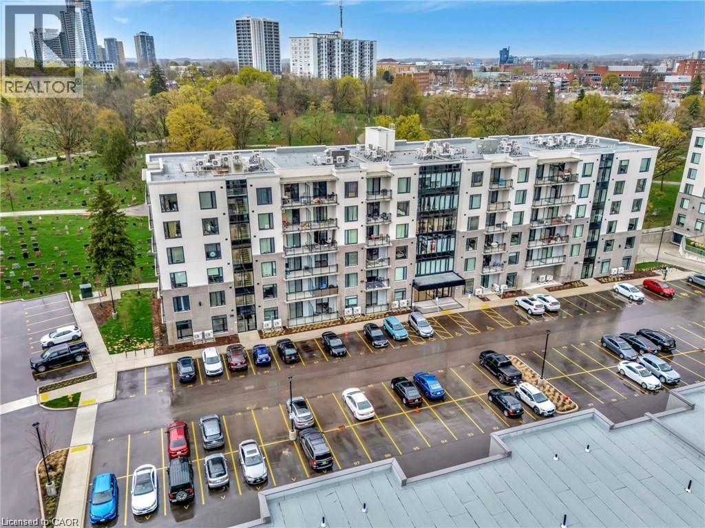 A large white building with a parking lot in front of it.