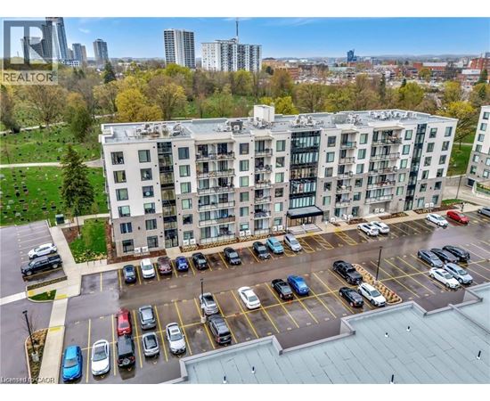A large white building with a parking lot in front of it.
