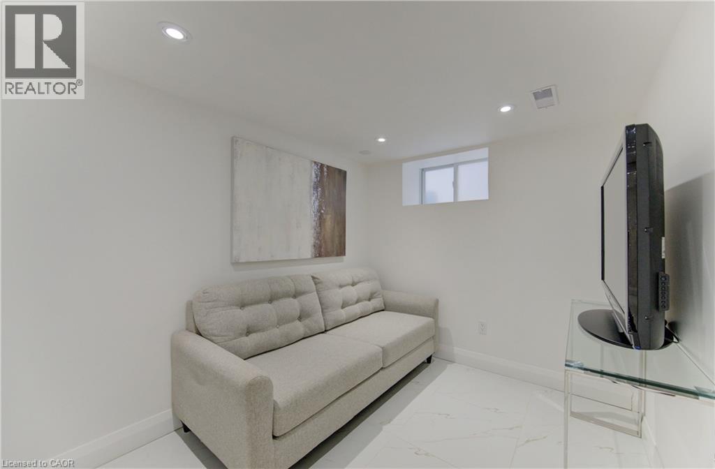 A living room with a couch, television, and a glass table.