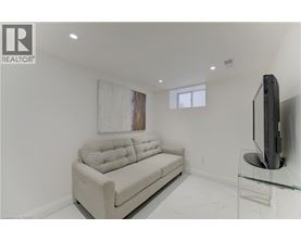 A living room with a couch, television, and a glass table.